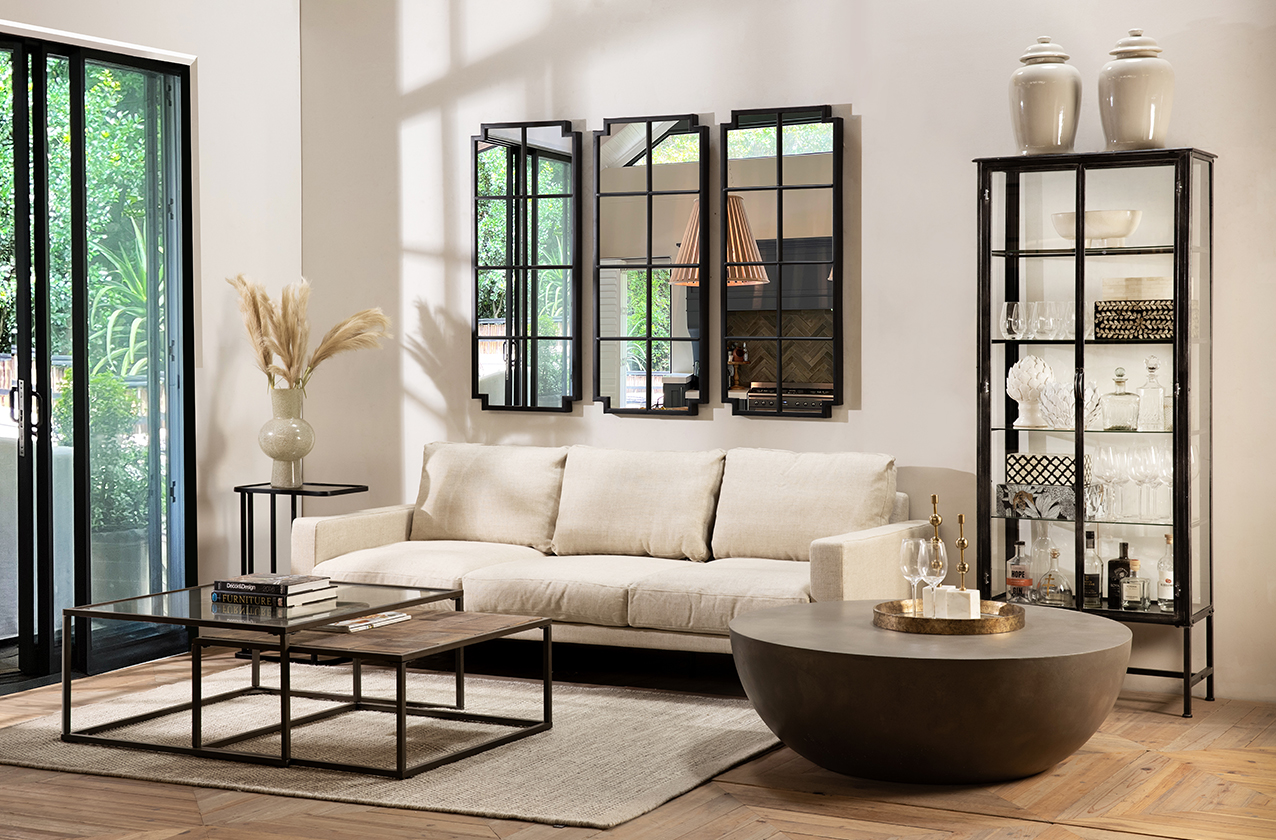 contemporary lounge with strong black metal framed coffee table, display cabinet and mirrors