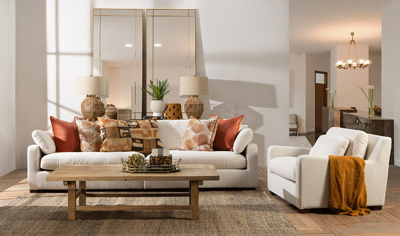 Generous white sofa in a contemporary style in white in earthy Bohemian living room look 
