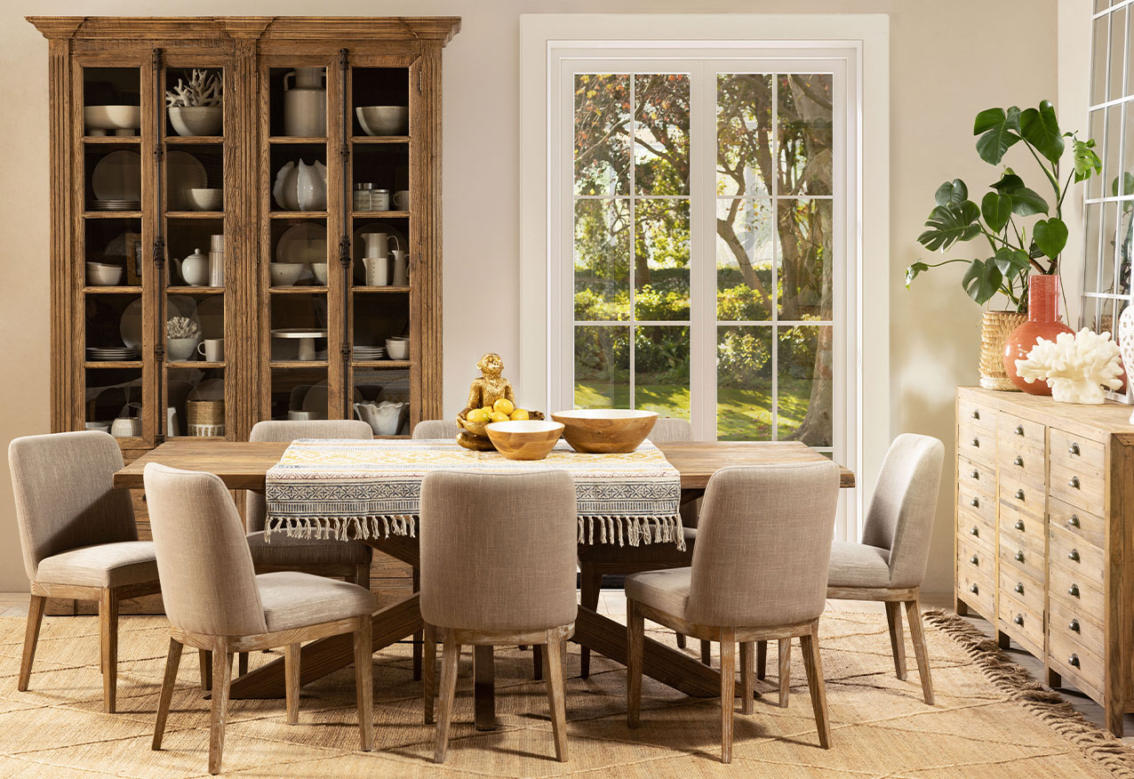 Neutral dining room with plush beige chairs and wooden table