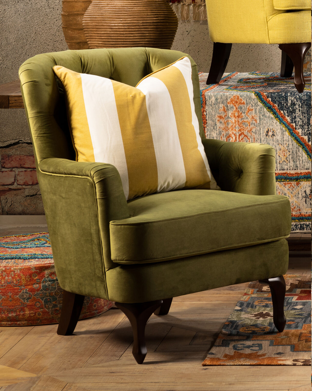 Fully upholstered green velvet chair with deep button back and cabriole leg.