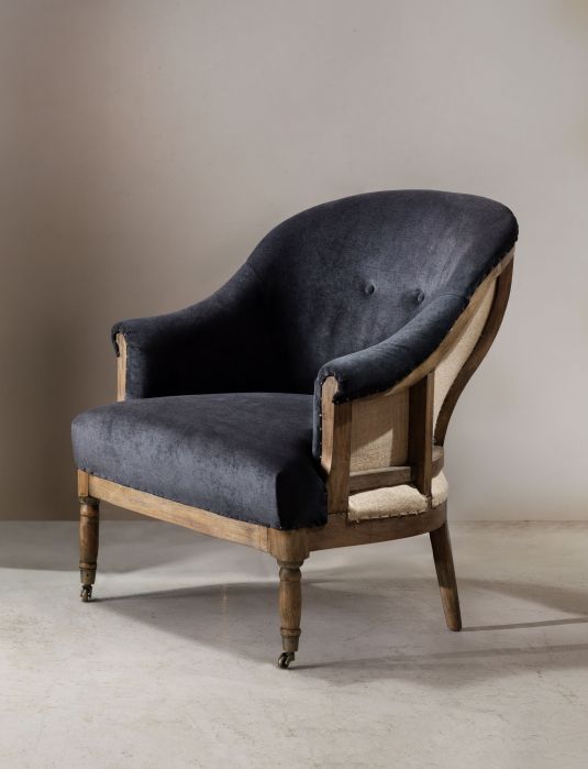 Deconstructed occasional chair with castors, upholstered in charcoal fabric