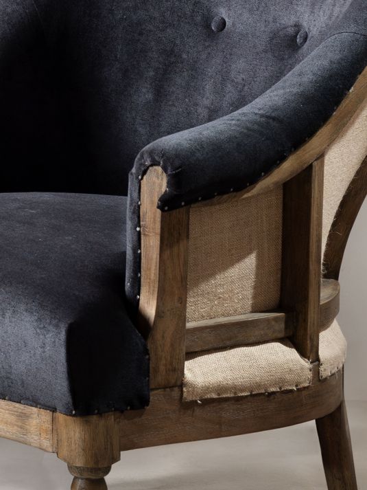 Deconstructed occasional chair with castors, upholstered in charcoal fabric