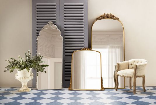 Gold framed mirror with ornate top