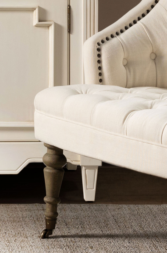 cream upholstered deco chair with deep buttoned detail, oak legs and castors, Château Collection 