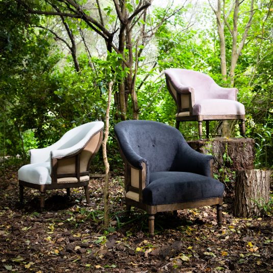 Deconstructed occasional chair with castors, upholstered in charcoal fabric