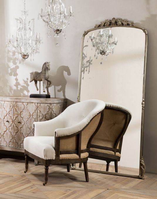 Deconstructed occasional chair with castors, upholstered in ivory fabric.