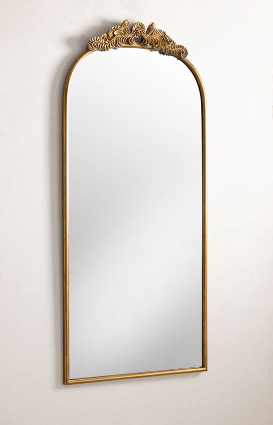 Gold framed mirror with ornate top