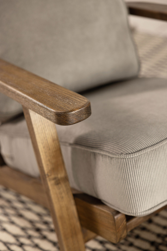Wooden frame lounge chair with loose cushions upholstered in a grey fabric.