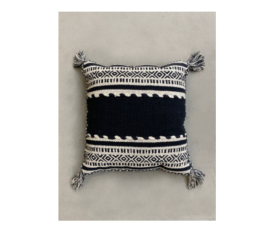 black and white knitted cushion with tassels