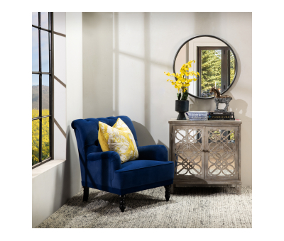 blue velvet upholstered armchair with button back detail