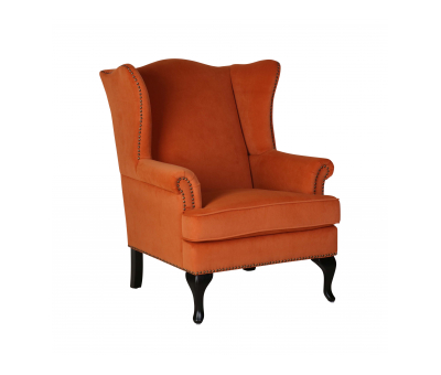 upholstered wingback chair in burnt orange velvet with stud detail