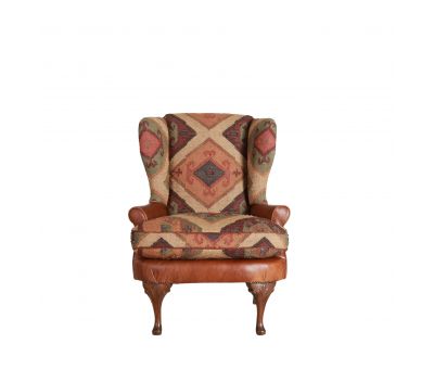 kilim and tan leather wingback chair