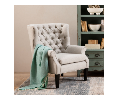 grey upholstered high back buttoned armchair