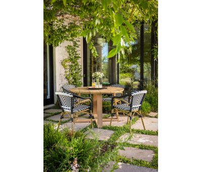 Round outdoor dining table in iroko