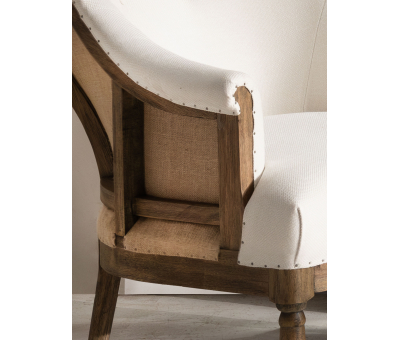 Deconstructed occasional chair with castors, upholstered in ivory fabric.