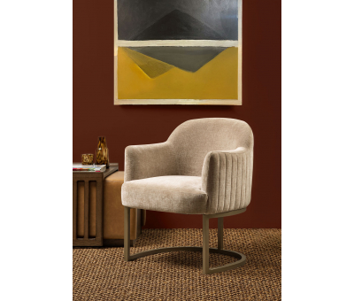 modern armchair in stone with brushed bronze metal base 