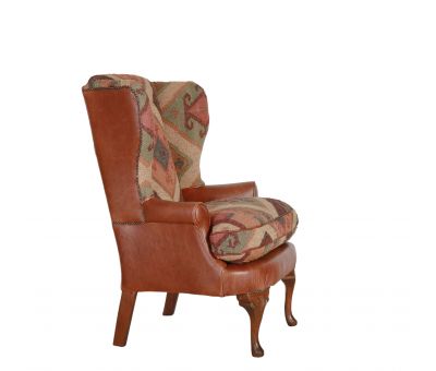 kilim and tan leather wingback chair