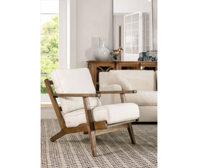 Wooden frame lounge chair with loose cushions upholstered in a ivory fabric.