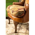 kilim and tan leather wingback chair