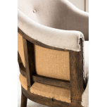 Linen upholstered deconstructed armchair on castors.