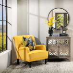 yellow velvet upholstered armchair with button back detail
