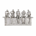 Silver figures on a shelf waiting and contemplating decor