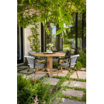 Round outdoor dining table in iroko