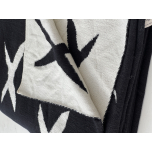 Monochrome knitted throw with reversible X pattern