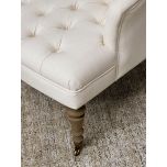 cream upholstered deco chair with deep buttoned detail, oak legs and castors, Château Collection 