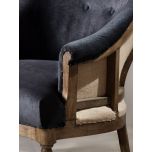 Deconstructed occasional chair with castors, upholstered in charcoal fabric