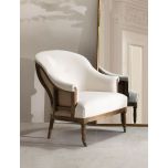 Deconstructed occasional chair with castors, upholstered in ivory fabric.