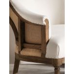 Deconstructed occasional chair with castors, upholstered in ivory fabric.