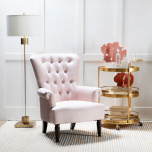 pink velveteen armchair with high tufted back and wooden legs
