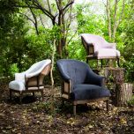 Deconstructed occasional chair with castors, upholstered in charcoal fabric