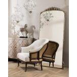 Deconstructed occasional chair with castors, upholstered in ivory fabric.