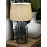 table lamp with black cage-like metal base and linen shade 