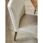 cream upholstered Harley chair with oak legs