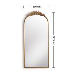 Gold framed mirror with ornate top