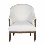 Deconstructed occasional chair with castors, upholstered in ivory fabric.