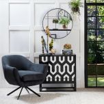 Swivel tub chair with black metal legs upholstered in a charcoal fabric.