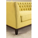 yellow upholstered sofa with buttoned back detail