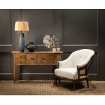 Deconstructed occasional chair with castors, upholstered in ivory fabric.