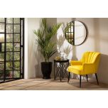 yellow velvet fan back chair with black legs