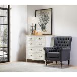 upholstered armchair with deep button detail and castors