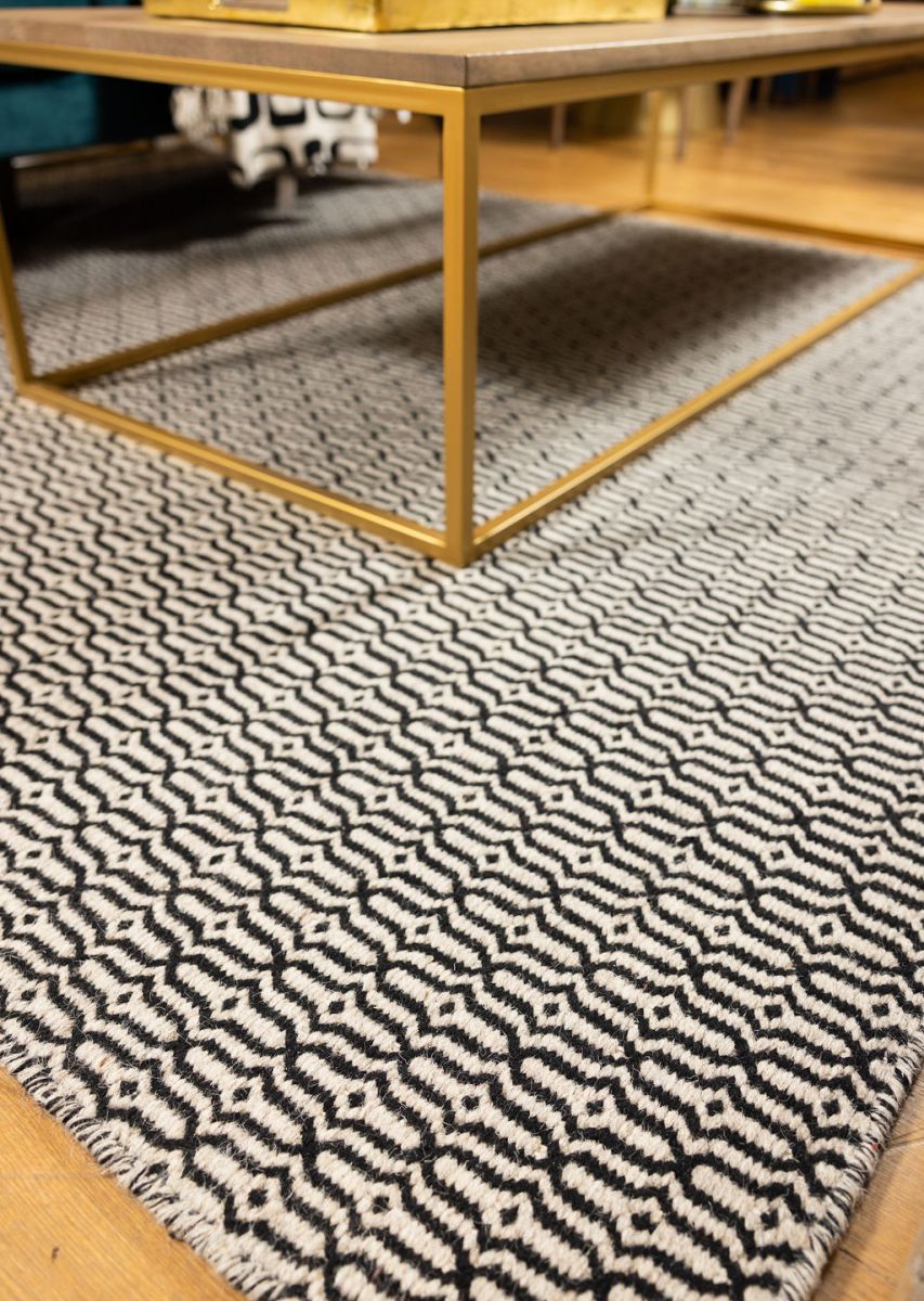 Block & Chisel stone coloured wool rug with black pattern detail