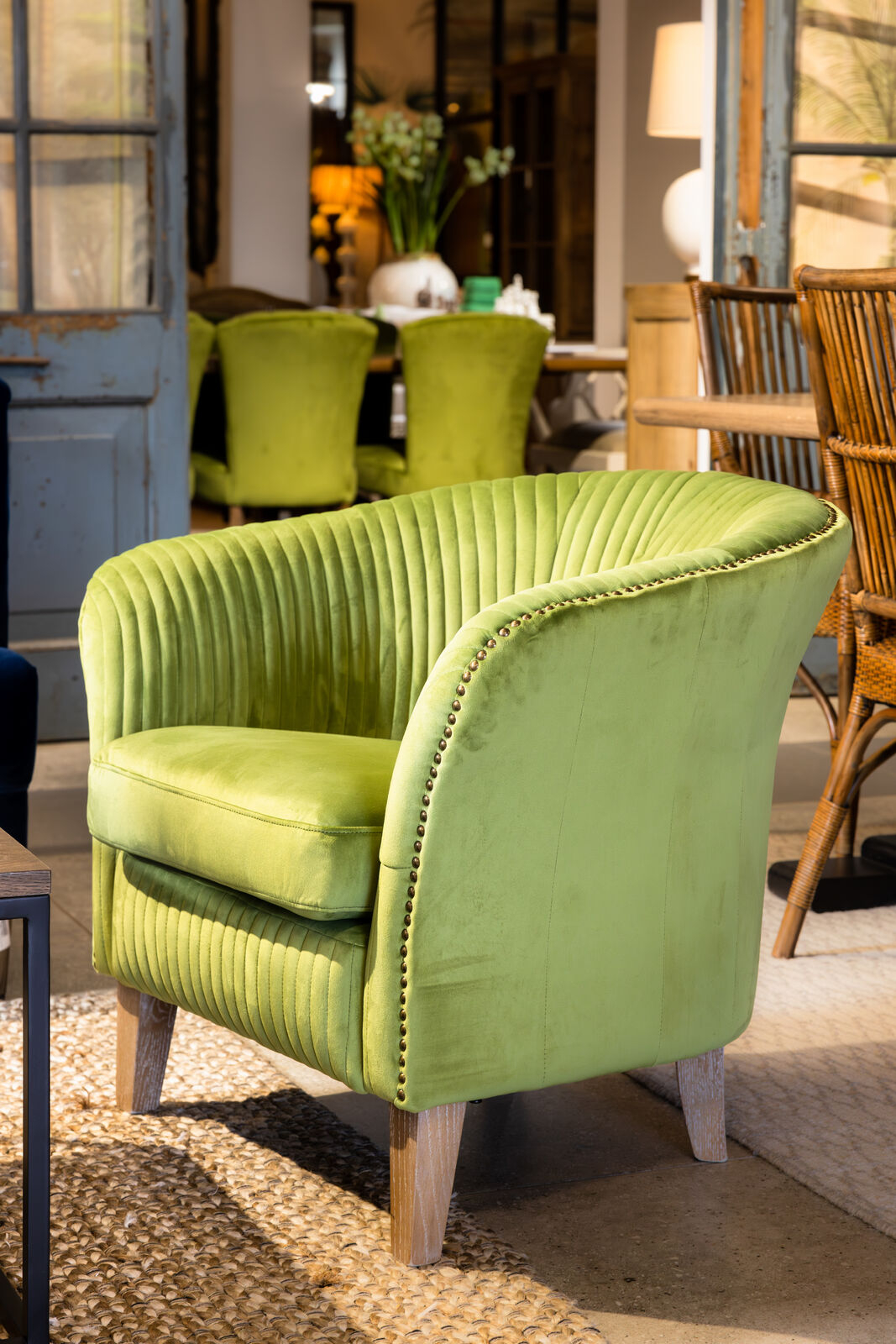 Green velvet tub armchair with stud detail