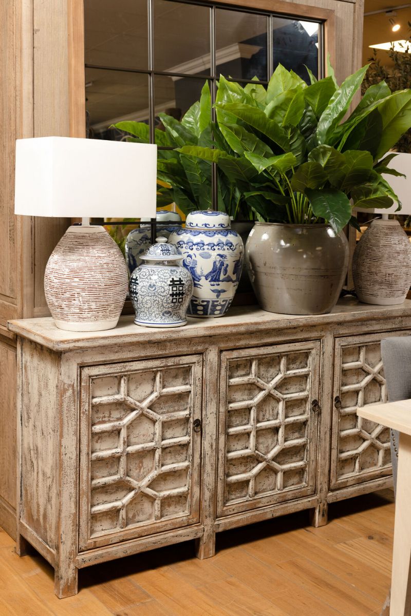 White chinese sideboard with detailed doors.