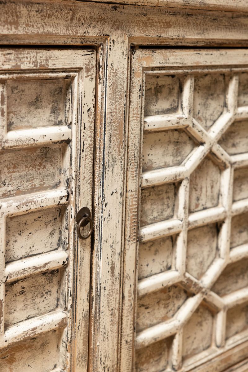 White chinese sideboard with detailed doors.