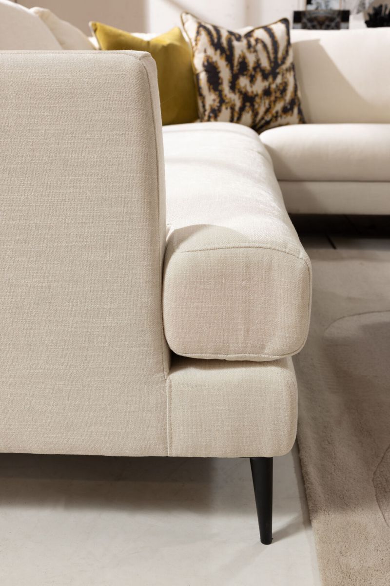 cream modern corner unit with freestanding ottoman