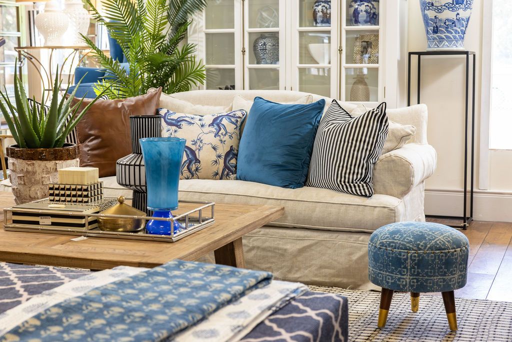 blue upholstered stool with 3 legs